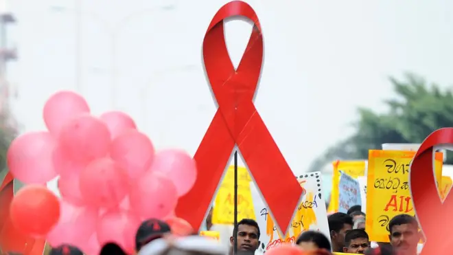 Sri Lankan prisoners hold placards as they take part in a gathering to mark World AIDS Day at a prison complex in Colombo on December 1, 2013. Some 1,808 HIV positive cases have reportedly been identified in the country between 1987 and the end of November 2013. AFP PHOTO/ Ishara S.KODIKARA (Photo credit should read Ishara S.KODIKARA/AFP/Getty Images)