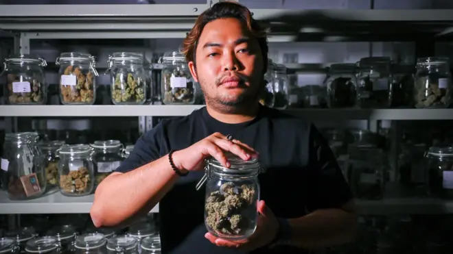 대마꽃이 들어있는 병을 들고 있는 남성