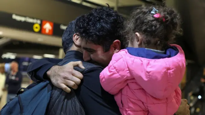 أخوان إيرانيان يتعانقا إثر الإفراج عنهما بعد احتجازهما، في مطار سيتال-تاكوما الدولي لإخضاعهما لمزيد من إجراءات الفحص تنفيذا لقرار ترامب.