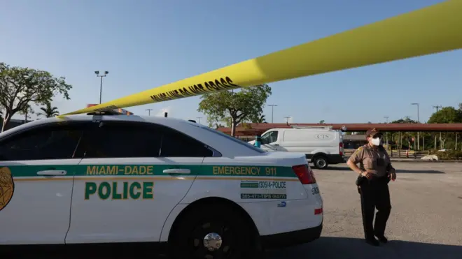 Officers examine the scene of a shooting outside a banquet hall in Hialeah, Florida