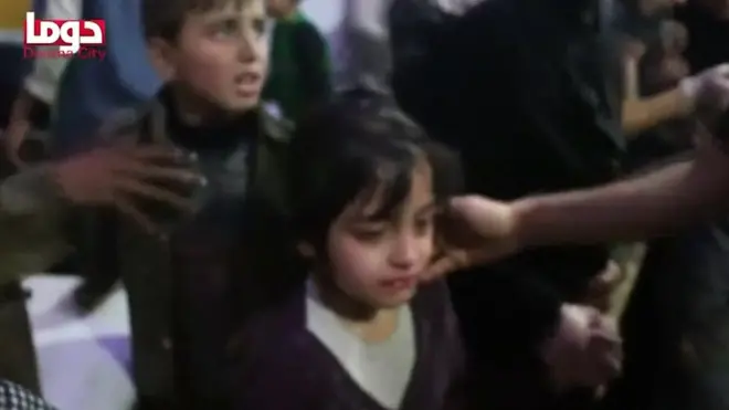 Children are given medical checks in what is said to be the rebel-held Syrian town of Douma, 7 April