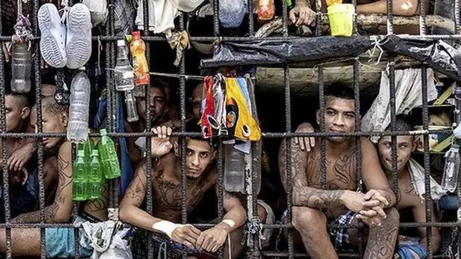 Inmates look out of an overcrowded cell in the Penal Center of Quezaltepeque, El Salvador. 9 November, 2018