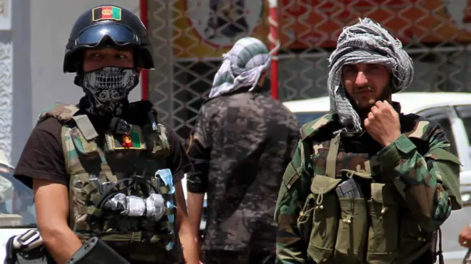 Afghan security officials patrol after they took back control of parts of Herat city
