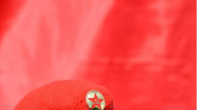 JVP beret in red background