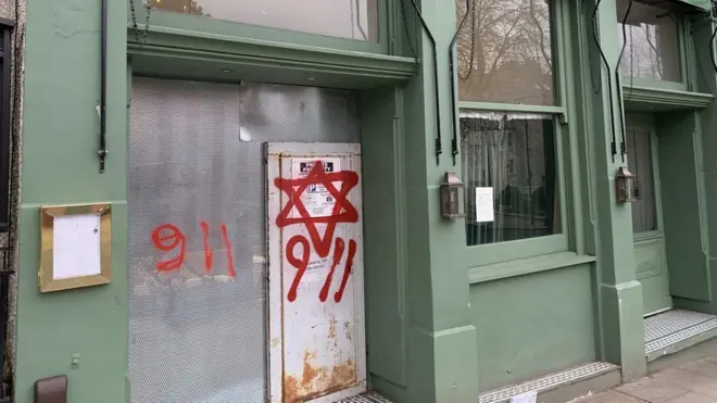 The graffiti could reference an anti-Semitic conspiracy theory that Jews are responsible for the 9/11 terror attack