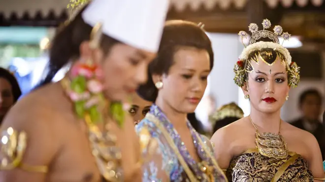 Eldest daughter in middle and her younger sister on her wedding day