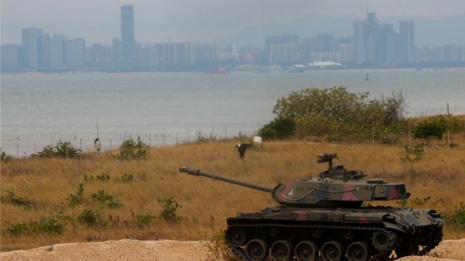 A retired military tank is seen on the beach with China in the background in Kinmen, Taiwan December 20, 2023