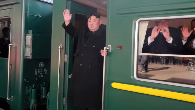 Kim Jong-un melambaikan tangan dari kereta ikoniknya, saat meninggalkan Pyongyang menuju Hanoi. Foto ini dirilis kantor berita KCNA pada tanggal 23 Februari.