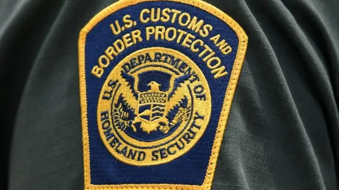 A US Customs and Border Protection patch is seen on the arm of an agent