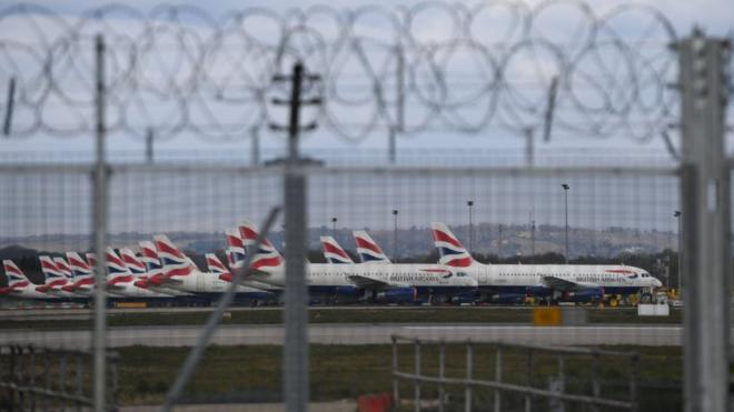 BA planes seen behind barbed wire fence