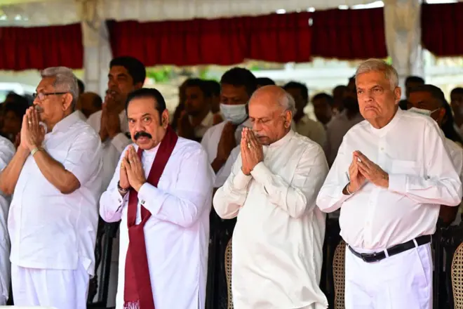 President Ranil Wickremesinghe (R), former President Gotabaya Rajapaksa (L), former President Mahinda Rajapaksa (2L) and Prime Minister Dinesh Gunawardena (2R) attends funeral of a top Buddhist monk, Galaboda Gnanaissara, in Colombo on August 5, 2024.