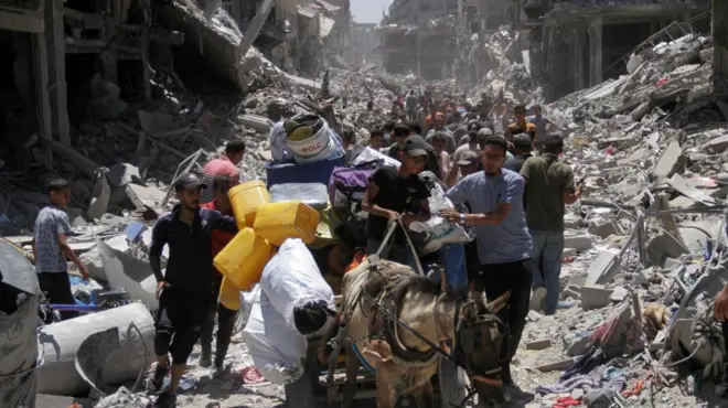 A group of Palestinians surrounded by destroyed buildings