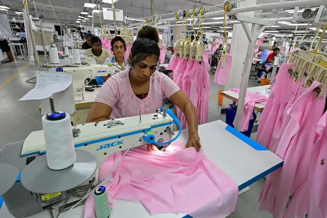 Employees sew garments inside a garment factory in Katunayake free trade zone