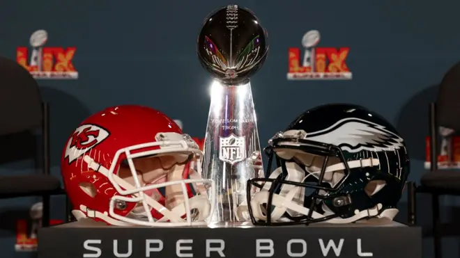 Di Super Bowl trophy and Chiefs and Eagles helmets