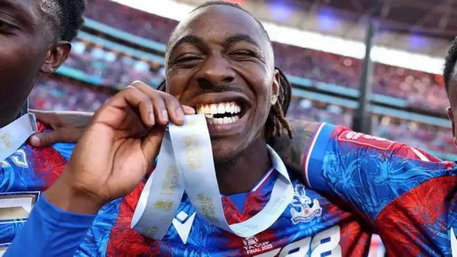 Eberechi Eze pose wit im FA Cup medal afta Crystal Palace win di cup