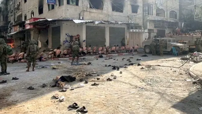 අවවාදයයි : කම්පනයට පත්විය හැකි දර්ශන අඩංගුය ඊශ්‍රායල සොල්දාදුවන් විසින් ගාසා තීරයේ අත්අඩංගුවට ගෙන රඳවාගෙන පලස්තීනුවන්ගේ වීඩියෝවක් සමාජ මාධ්‍යට නිකුත් වී තිබේ. බිම දණින් වැටී ඊශ්‍රායල සොල්දාදුවන්ගේ දැඩි රැකවල් මැදසිටින එම පලස්තීනුවන්ගේ යට ඇඳුම් දක්වා ඊශ්‍රායල හමුදා විසින් නිරුවත් කොට ඇති අතර බීබීසීය විසින් එම දර්ශන උතුරු ගාසාවේ බීට් ලහියා හී රූගත කරන ලද බව තහවුරු කරගෙන ඇත. ඊශ්‍රායලයේ ගාසා තීරයට බෝම්බ හෙලීම අඛණ්ඩව සිදුවෙමින් තිබේ. එක්සත් ජාතීන්ගේ සංවිධානය වහාම සටන් විරාමයක් ඉල්ලා සිටින අතර එහි ආධාර වැඩසටහන තවදුරටත් ක්‍රියාත්මක නොවන බවට අනතුරු අඟවයි.