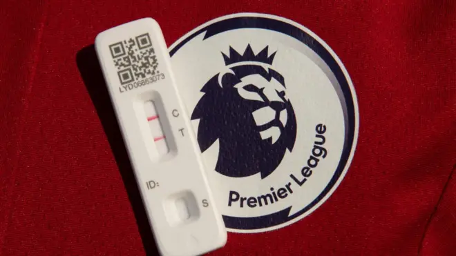 A Premier League crest and a COvid test