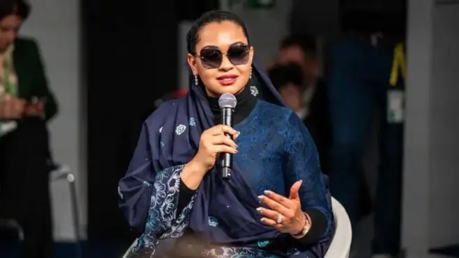 Foto of Senator Natasha Akpoti-Uduaghan wey wear navy blue cloth as she hold microphone dey tok.