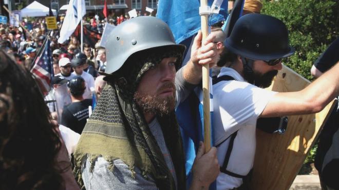 A white supremacist wearing a World War II German helmet arrives at a rally in Charlottesville, Virginia, U.S., August 12, 2017