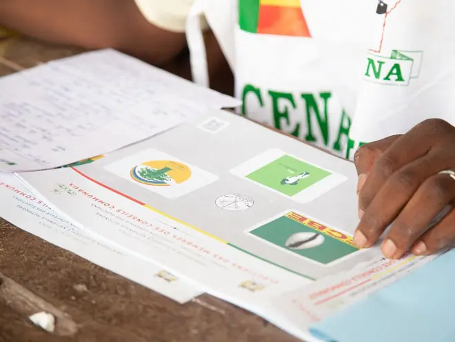 Un membre de la CENA veille au bon déroulement du scrutin le jour des élections législatives béninoises à l'école primaire YLOMAHOUTO d'Abomey-Calavi, au Bénin, le 11 janvier 2026. 