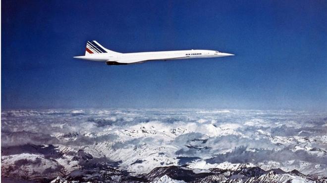 Concorde flying over some snowy mountains