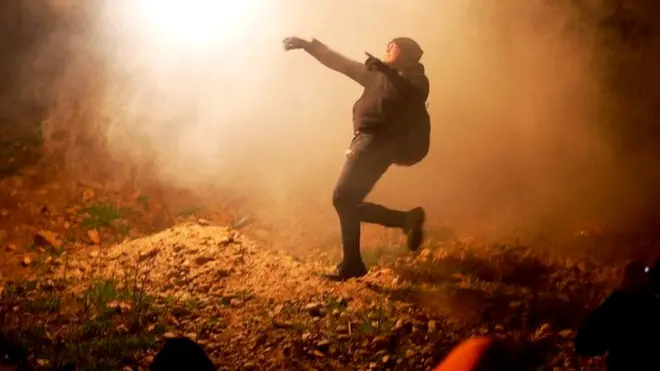 Some threw the canisters back over the border wall into the US