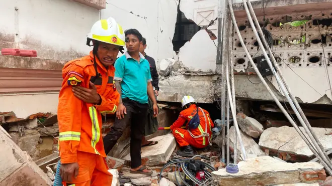 Rescuers search for survivors in damaged government staff housing buildings following an earthquake in Naypyidaw, Myanmar