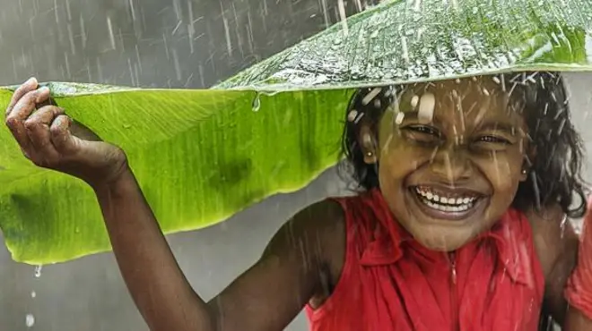 Local Sri Lankan girls shelter from the rain.