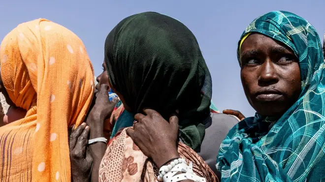 Women who have fled Darfur queue to register themselves at a camp in Chad, in October 2025.