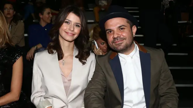 Beren Saat ve Kenan Doğulu yan yana oturuyor. Doğulu bir şapka takıyor. 
