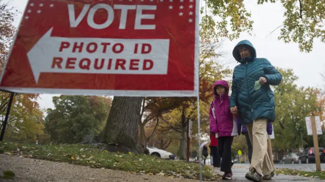 A woman walks to a polling station in Virginia
