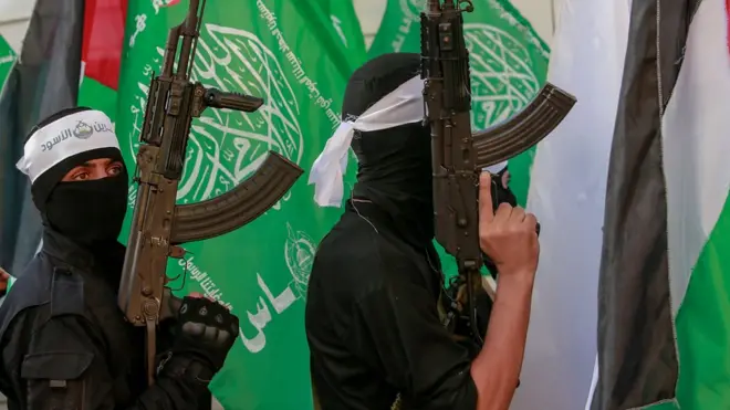 Fighters belonging to the Lion's Den group of the Al-Qassam brigades march during the preparations for the 14 December celebrations of the 35th founding anniversary of Hamas, in the north of Gaza City, 10 December 2022.