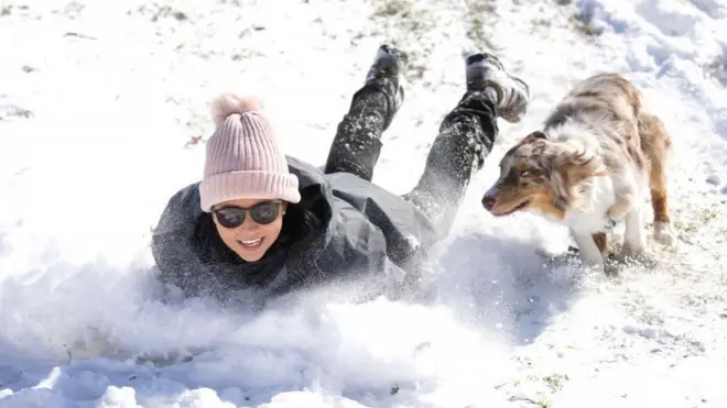 In Fort Worth Megan Pennartz and her dog Jensen have plenty of snow to enjoy