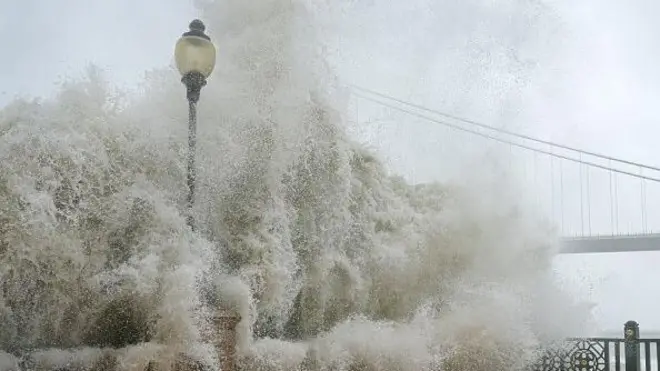  Waves crash ontop pier as Typhoon Ragasa hit Hong Kong on September 24, 2025. Hong Kong hoist typhoon signal Number 10 as di city dey prepare for powerful typhoon of 2025.