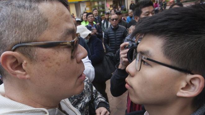 An unknown heckler (L) faces off with pro-democracy activist Joshua Wong (R) at an election rally for Hong Kong Legislative Council by-election pro-democracy candidate Au Ngok-hin in Aberdeen Square in the Hong Kong Island geographical constituency, Hong Kong, China, 11 March 2018. Hong Kongers go to the polls 11 March 2018 to vote for four new lawmakers after the disqualification of four lawmakers for what Hong Kong"s High Court ruled was improper oath-taking in a swearing-in ceremony after the 04 September 2016 Legislative Council elections. EPA/ALEX HOFFORD