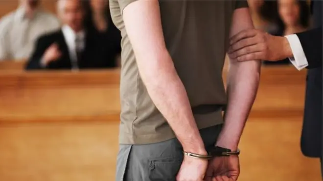 Човек са лисицама на рукама