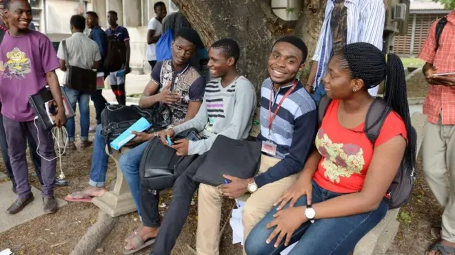 Students resting under a tree
