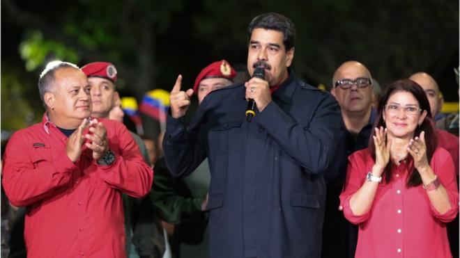 President Nicolas Maduro flanked by supporters
