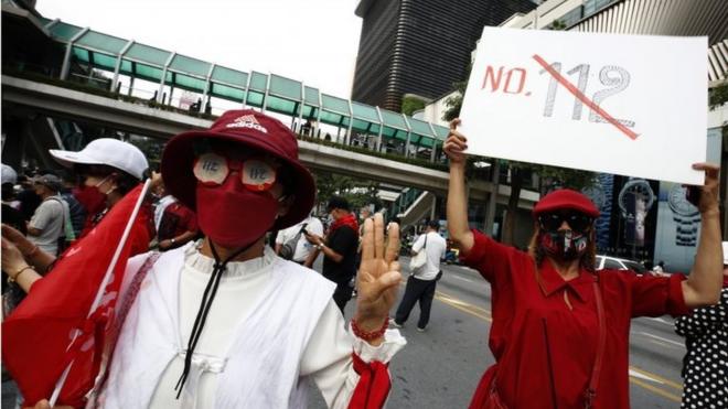 Thai anti-government protesters flashe three-finger salute with a message "No 112" of lese majeste law as they gather to protest against the lese majeste law in Bangkok, Thailand, 31 October 2021