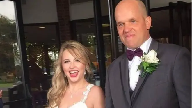 Heather and Christopher Dempsey smile for the cameras on their wedding day