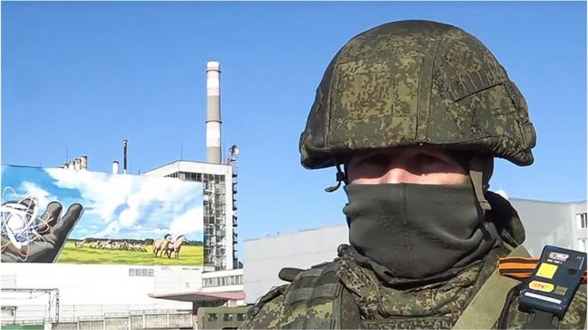 A Russian soldier in front of Chernobyl