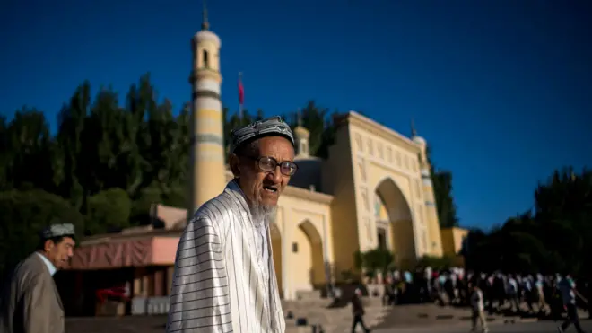 This picture taken on June 26, 2017 shows a Muslim man arriving at the Id Kah Mosque for the morning prayer on Eid al-Fitr in the old town of Kashgar in China's Xinjiang Uighur Autonomous Region.
