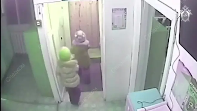 Video grab of two five-year-old girls leaving their nursery during bitter Siberian winter