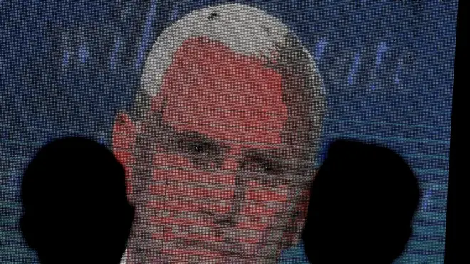 People watch the debate between U.S. Vice President Mike Pence and Democratic vice-presidential nominee Kamala Harris outside a tavern in San Diego, California, U.S., October 7, 2020