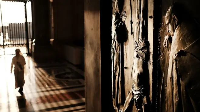 A door to St. Peter's Basilica in the Vatican stands open in the dawn light