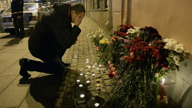 A man reacts as he places flowers in memory of victims of the blast in the Saint Petersburg metro outside Technological Institute station on April 3, 2017