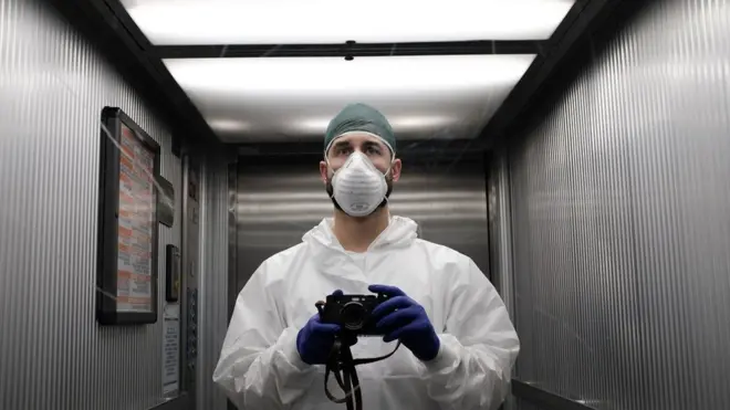 A member of hospital staff with a camera