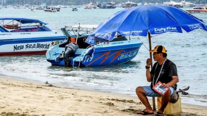 A speedboat vendor awaits for tourists in Pattaya, a beach resort that is normally a magnet for Chinese tourists, but which is now empty