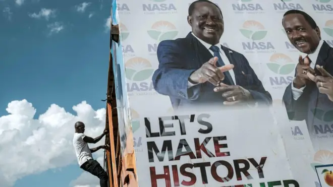 Opposition leader Raila Odinga (left on poster) successfully challenged August's result in court