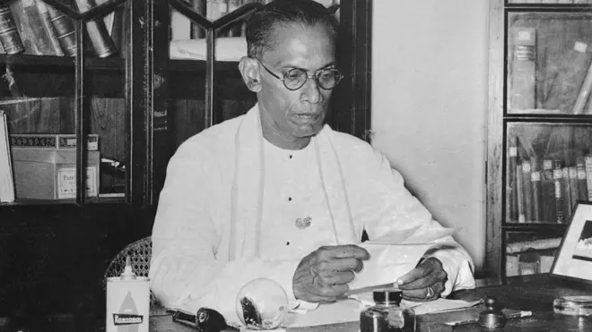 Seated at a desk in his residence here is S.W.R.D. Bandaraike, the newly elected Prime Minister of Ceylon. 